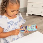 Bluey-themed toddler remote control placed on a nursery shelf with Australian-made branding.