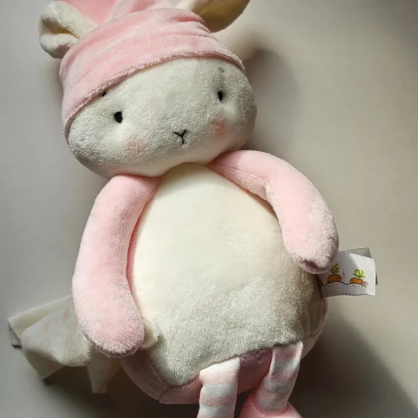 Close-up detail of the locally sourced, sustainable baby plush toy being held gently to display its premium, cloud-like texture.